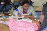UON Performance contract representative perusing through the administration department copies of evident