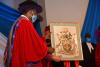 The Chancellor hands the logo over to the Vice Chancellor